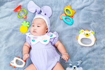 Baby boy in bunny costume,Cute baby Easter bunny. Little baby boy with bunny ears and Easter eggs...