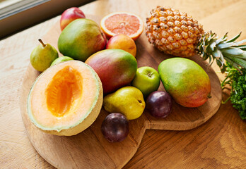 Top view, fruit and healthy food with nutrition, kitchen counter and salad with ingredient for smoothie, home and vegan. Apartment, snack and vegetarian on wooden surface, wellness or juicy with diet