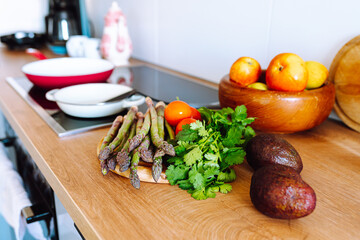 asparagus on wooden board on kitchen surface