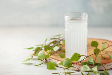 Traditional birch sap. Birch juice in drinking glass. A refreshing traditional Russian spring drink. Copy space