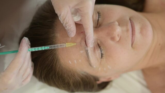 Close-up of a cosmetic procedure with an injection