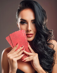 Gorgeous black hair woman holding her poker cards and looking straight at the opponent