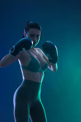 The Boxing. Topless woman boxer. Sportsman muay thai boxer fighting in gloves. Isolated on black...