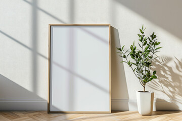 Frame mockup picture on wood floor against white wall, detail of modern minimalist room interior with blank poster and plant. Concept of home design, mock up, parquet.