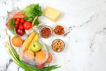 Healthy balanced diet with dietary ingredients, vegetables, fruits, nuts and cheese for weight...