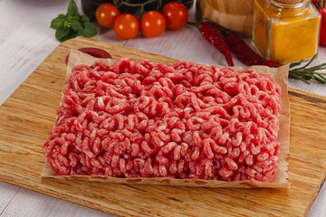 Raw minced beef meat over board