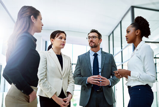 Business People, Serious And Discussion With Meeting In Lobby For Court Case, Planning And Collaboration. Attorney, Office And Teamwork At Law Firm For Communication, Legal Advice And Feedback