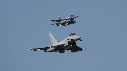 Fototapeta na wymiar jet fighters typhoon versus f-16 in action