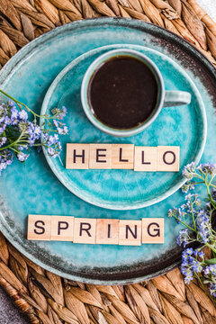 Spring greeting with coffee and forget-me-not flowers
