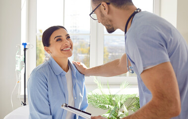 Male doctor engages in a consultation with a positive and smiling Female patient. The nurse professionalism and the patient's optimism create a harmonious atmosphere, fostering open communication.