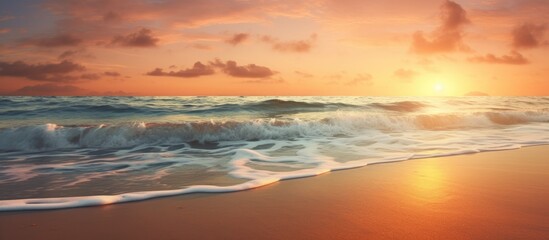 Sunset over the ocean with beach waves