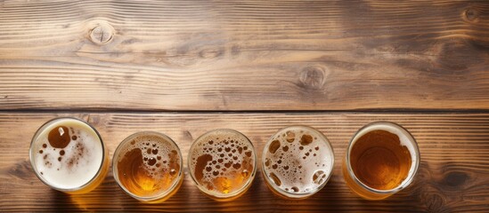 Five glasses of beer on wooden table