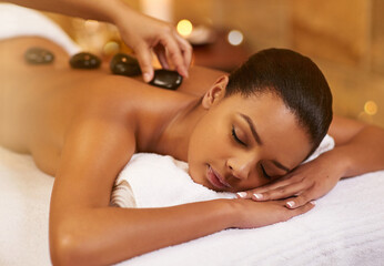 Spa, stone and woman with massage, wellness and relaxing with stress relief, skincare and vacation....