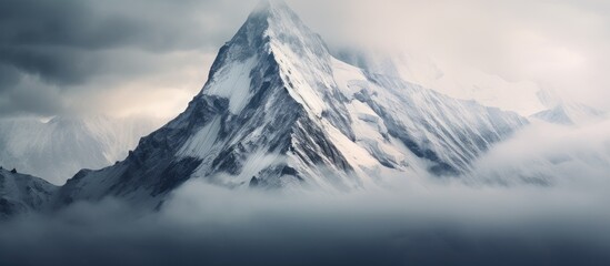Fototapeta premium Mountain with snow, clouds, bird in the sky