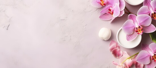Pink orchids and marshmallows in white bowls on pink background