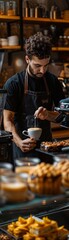 A man in a black apron is pouring coffee into a white cup