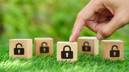 Woman hands point on Lock icon on wooden cube, Cyber security concepts, locking, lockdown and...