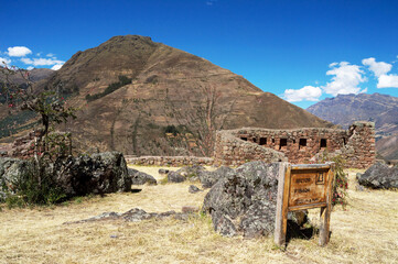 complex of well-preserved ruins in Pisac with a plaque stating its name written 