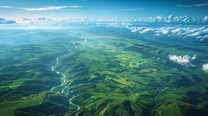 From above, an awe-inspiring landscape unfolds, captured from an airplane. A mesmerizing blue sky stretches above lush green fields, meandering rivers, and towering mountains. This vista beckons one t