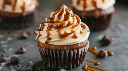 Delicious cupcakes with caramel on table, closeup. Delicious dessert - obrazy, fototapety, plakaty