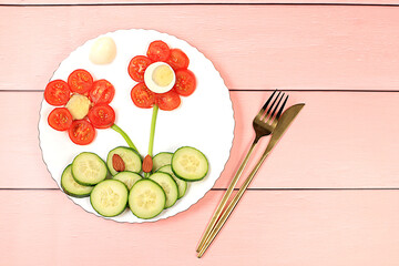 Healthy breakfast with ingredients, fun food for children, ideas for dish decoration, Healthy and natural food concept. Flower of tomatoes, cucumbers and eggs on a plate,