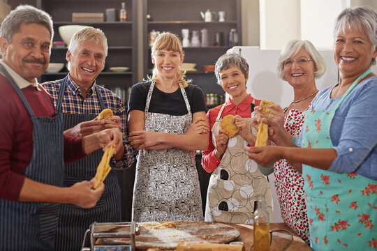 Cooking, pasta class and portrait of people in kitchen learning recipe for cuisine, culinary and chef skills. Retirement, teacher and and men and women with ingredients, dough and food for dinner - Powered by Adobe