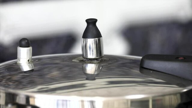 Pressure cooker in video with the valve rotating and original ambient sound.