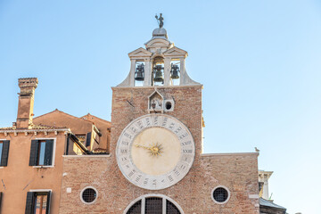 Fototapeta na wymiar View of the clock tower and campanile of the historical church San Giacomo di Rialto; Venice, Veneto, Italy
