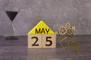 May 25th. Wooden cubes with date of 25 May on old blue wooden background.