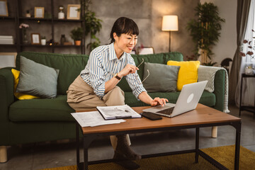 Mature japanese woman work from home on laptop