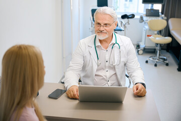 Female patient consulting with physician in clinic office