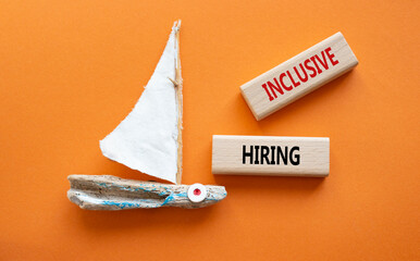 Inclusive Hiring symbol. Wooden blocks with words Inclusive Hiring. Businessman hand. Beautiful orange background with boat. Business and Inclusive Hiring concept. Copy space.