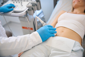 Top view of female getting ultrasound scan by doctor - 797063374