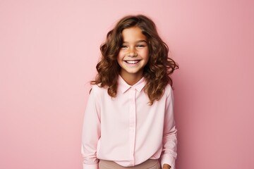 Fototapeta premium A young girl with long hair is smiling and wearing a pink shirt