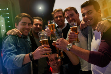 Men, beers and cheers with friends drinking at social event, restaurant or party with happiness. People, alcohol and glasses to toast at pub for happy hour, conversation or celebration together