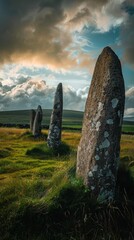 Ancient Standing Stones in a Lush Green Field at Sunset - obrazy, fototapety, plakaty