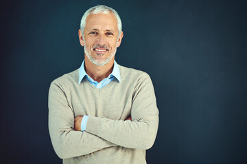 Mature, man and portrait of happy professor in studio, blue background and education mockup. Smile,...