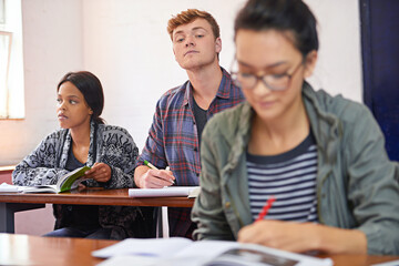 University student, man and copying test in classroom with reading, question paper and answers at...