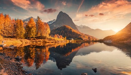 wonderful autumn landscape during sunset fairy tale moutain lake with picturesque sky majestic rocky mount and colorful trees at sunlight amazing nature scenery champfer lake switzerland alps