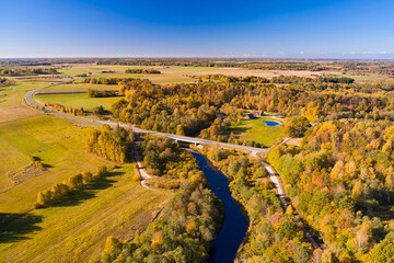 A bird's-eye view of the river road and young fresh fields - obrazy, fototapety, plakaty