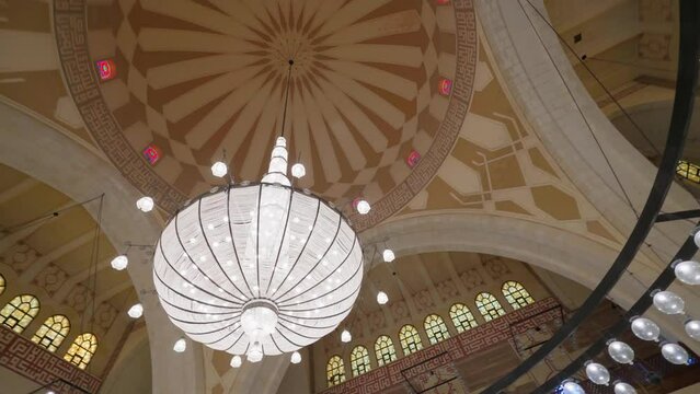 Manama, Bahrain - Jan 15 2024, 4k, Panoramic view of the interior, ceiling, dome and large glass chandelier of the Grand Mosque Al Fateh, Islamic cultural Center Al Fateh, Manama, Bahrain 