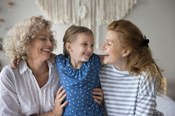 Happy three generational people hugging spend time together feeling unconditional love, gives...