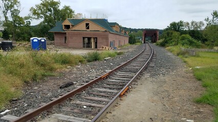 Old railway in the city with a new building being built next to it