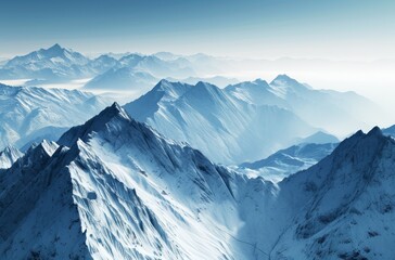Fototapeta premium Majestic snow-covered mountain range under a clear blue sky
