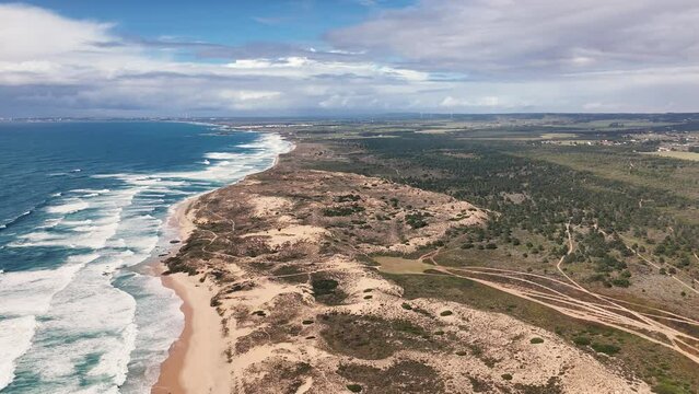 Vast panoramic view of the ocean waves and sand dunes. Portuguese western coast