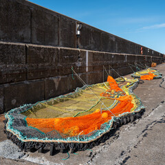 27 April 2024. Buckie Harbour,Moray,Scotland. This is a new Orange,Yellow and Blue Fishing Net tied...