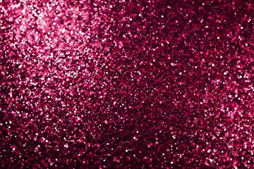 A close up of a pink glittery background