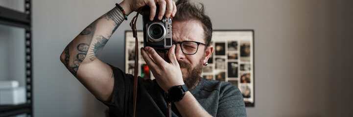 A creative photographer focuses a vintage camera, capturing unique moments against a backdrop of...