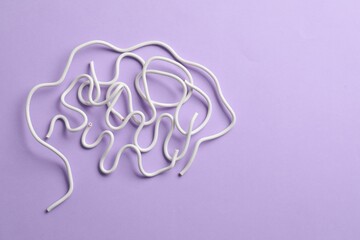 Amnesia problem. Brain made of wires on violet background, top view. Space for text