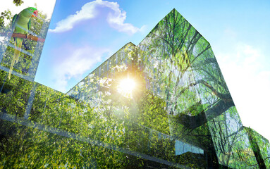 Double exposure of green trees on sunny day and buildings in city